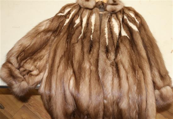 A three quarter length two tone mink coat